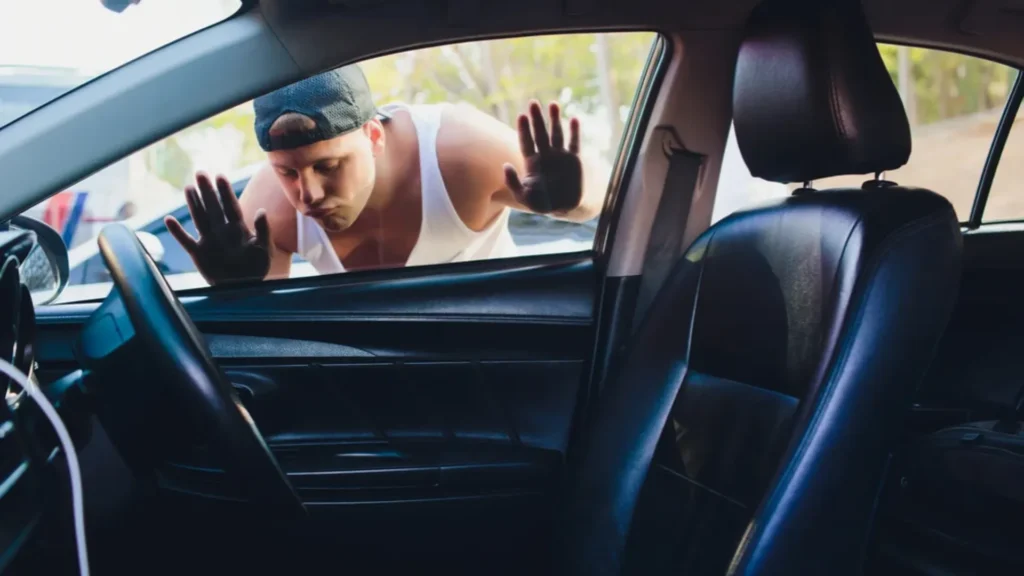 A guy staring at his keys inside a locked car