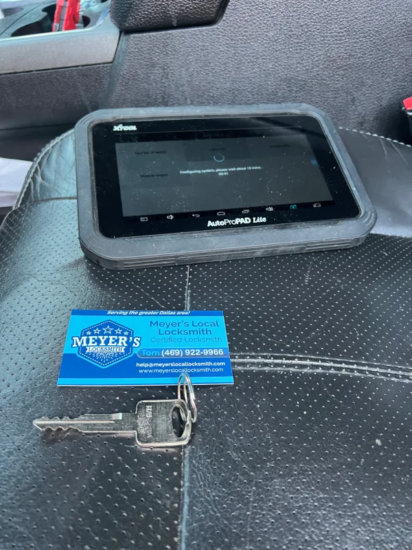 Key programming tablet and a newly cut transponder key ready for programming