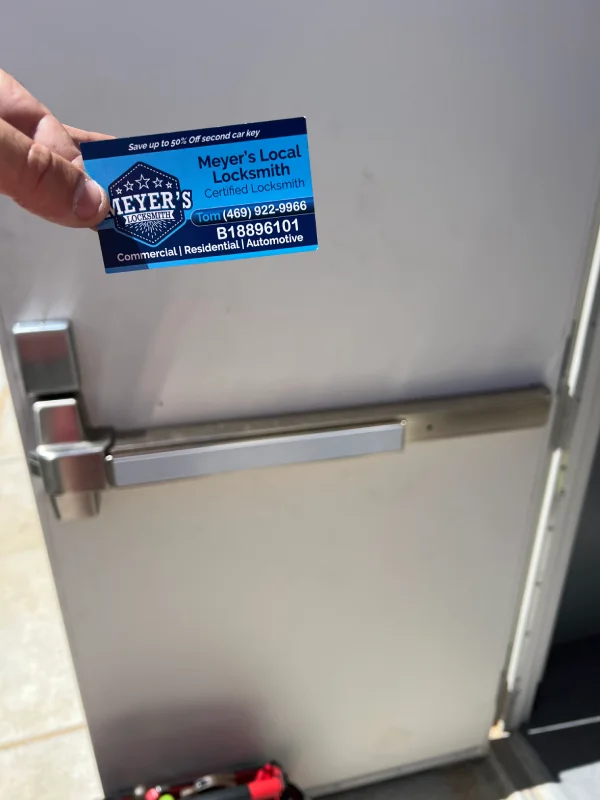Panic bar exit device installed on a commercial steel door in Collin County